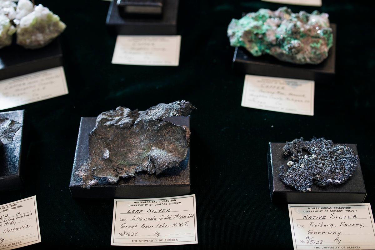 Mineral display shows labelled silver ore samples on black stands with museum information cards.