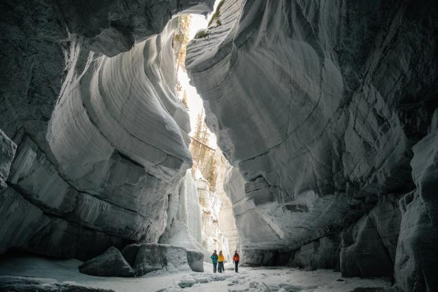 People walking through a very vast canyon.