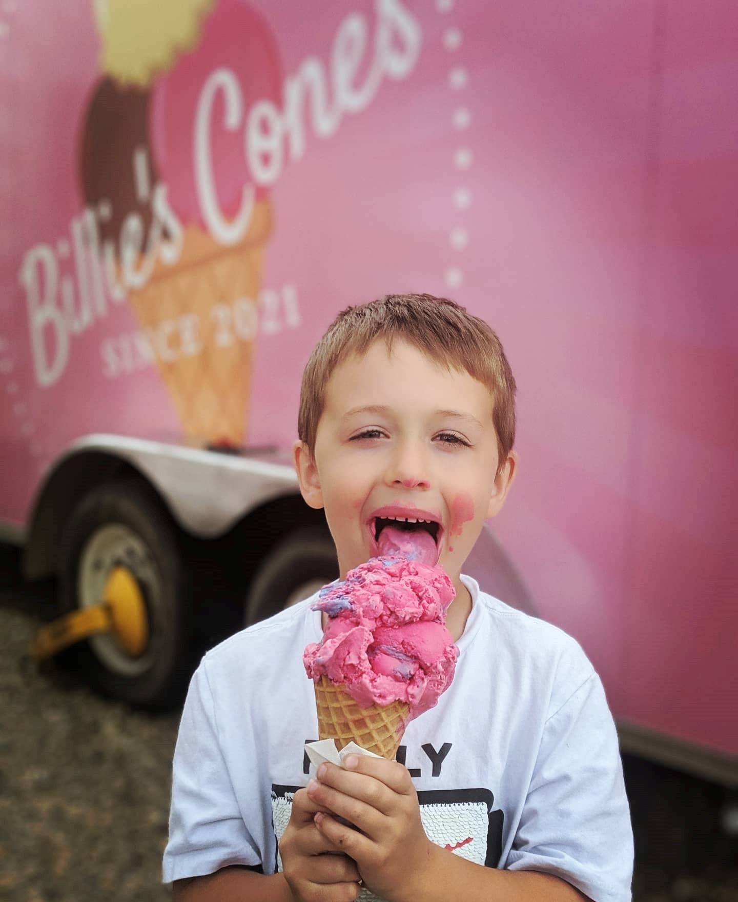 A boy licking an icecream cone