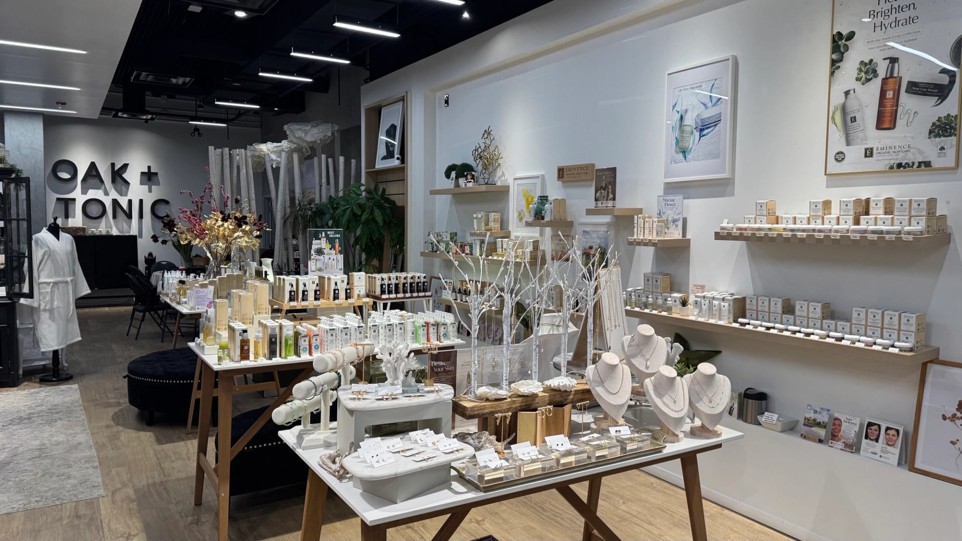 Oak + Tonic store interior with skincare displays, jewellery stands and wall shelves of products.