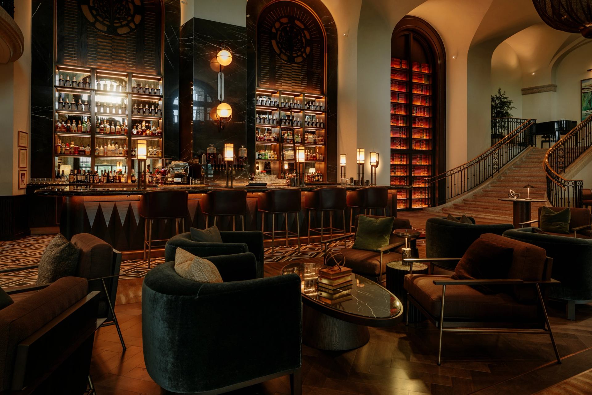 Elegant lounge with plush seating, grand bar, and warm ambient lighting at Rundle Bar.