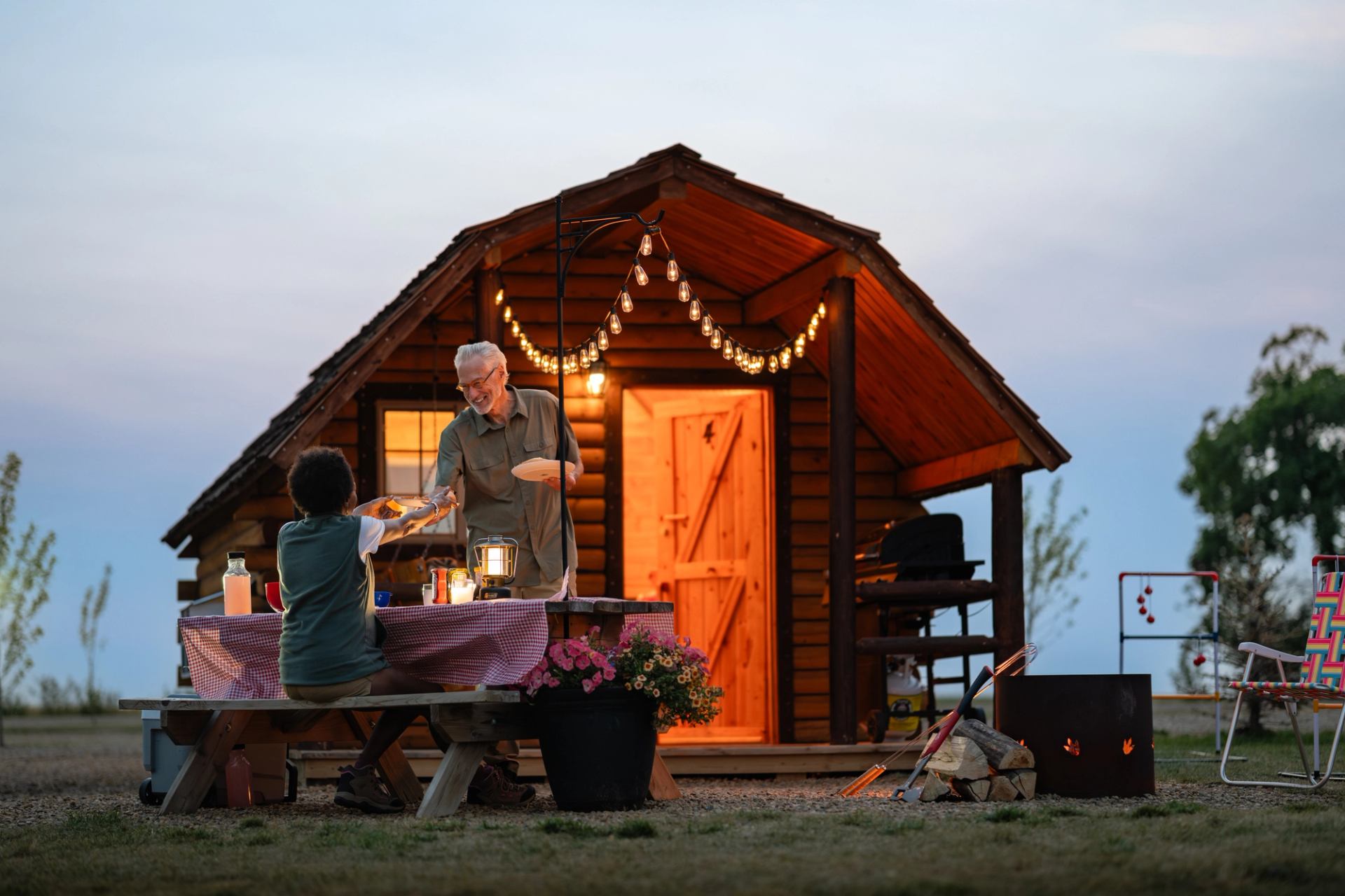 An elderly couple having a picnic outside a cottage at Horseshoe Canyon Campground & Cottages.