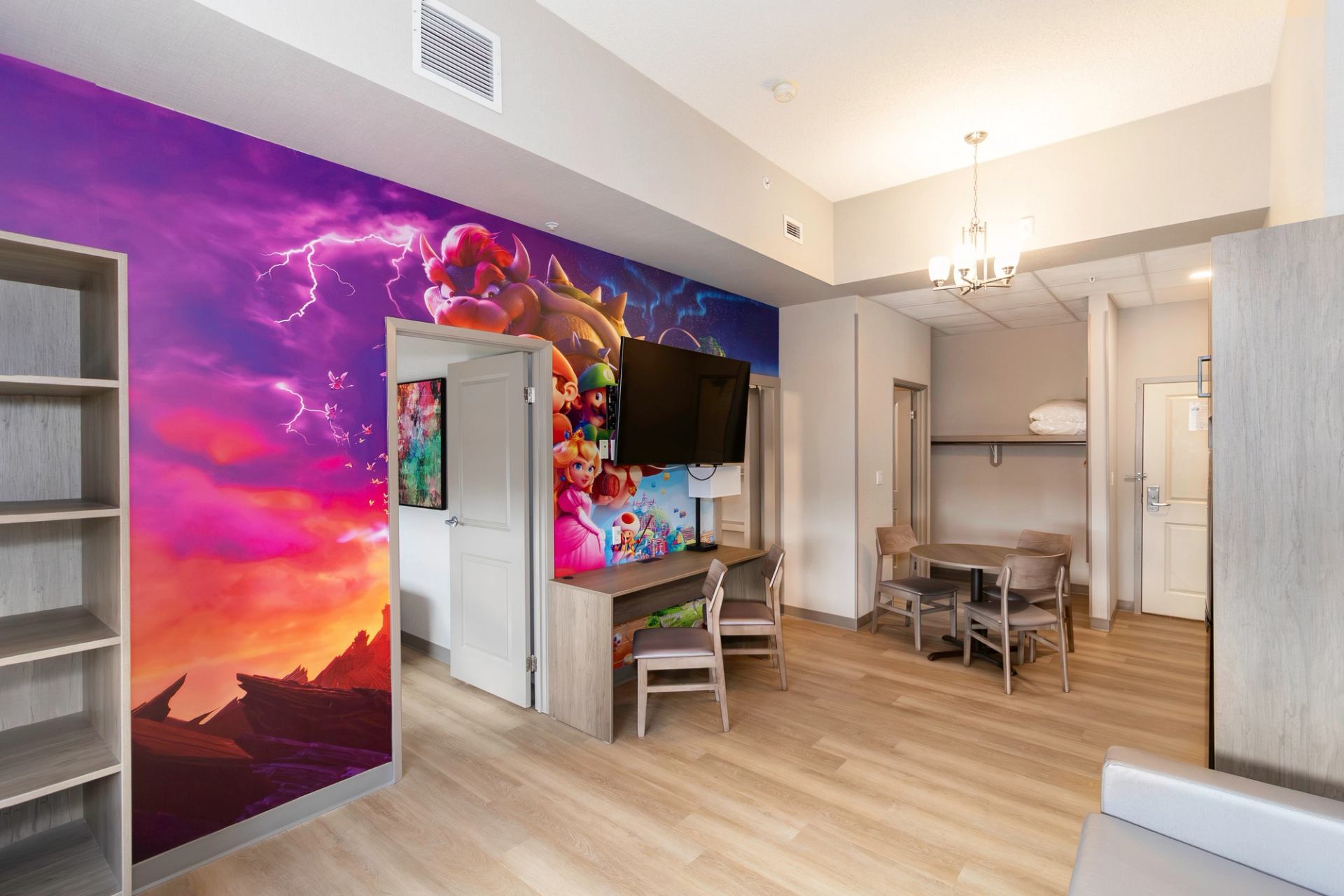 main living area of the kids theme room suite, main wall features mario and friends