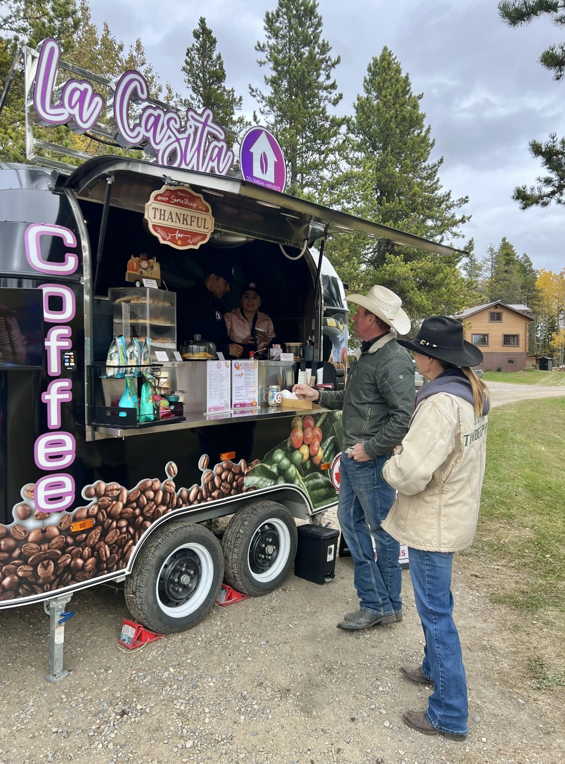 Customers in cowboy hats order from a La Casita coffee trailer.