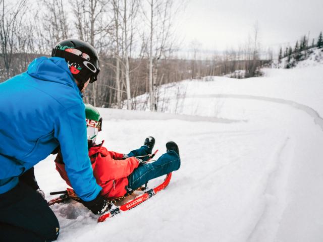 A child gets a push down the luge track at Nitehawk Adventure Park in Grande Prairie