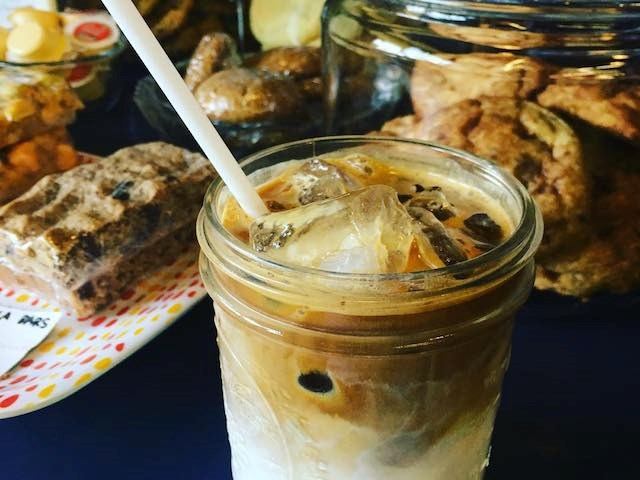 Iced coffee served in a mason jar with straw
