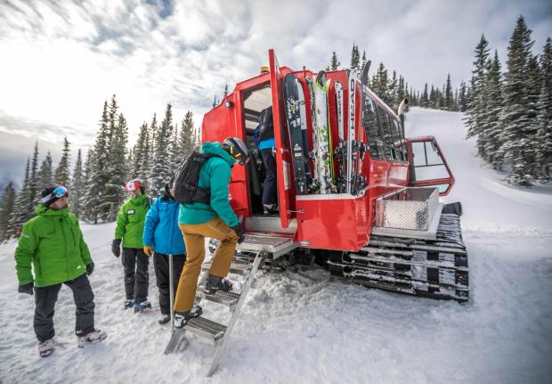 A group of skiers and snowboarders load their gear and themselves, before cat skiing at Castle Mountain.