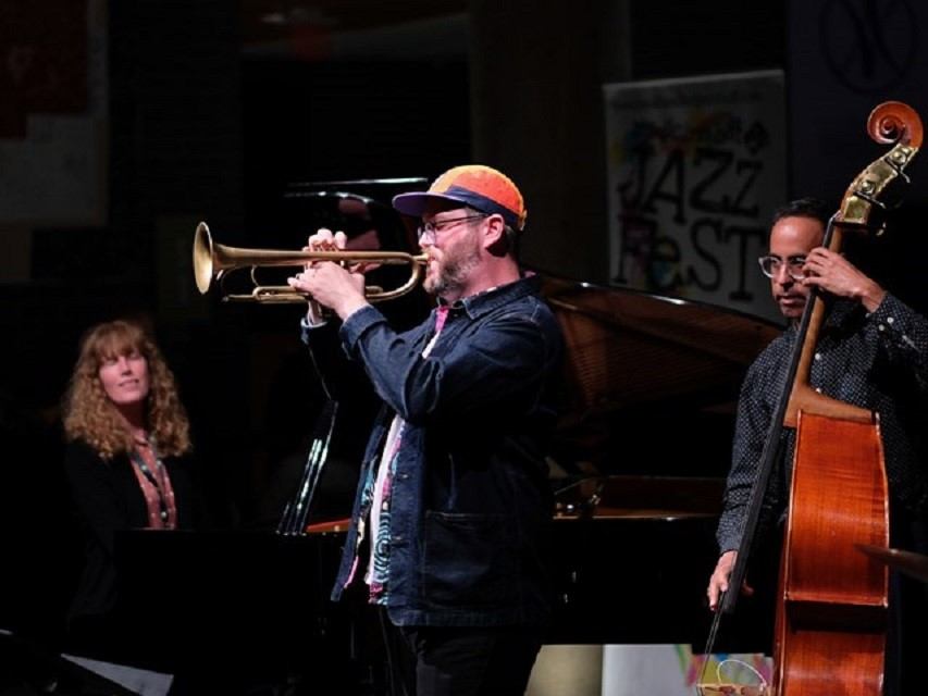 Trumpet player performs on stage with upright bass at Medicine Hat JazzFest.