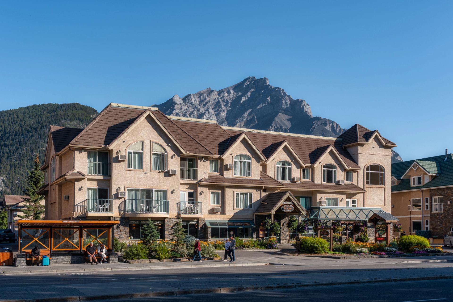 Irwin's Mountain Inn with scenic mountains and clear blue sky.