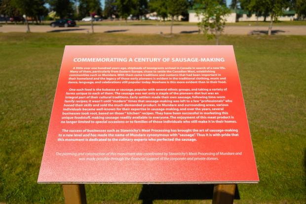 A plaque at the World's Largest Sausage statue in Alberta.