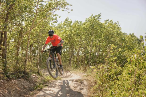 Person mountain biking on trail at WinSport in Calgary.