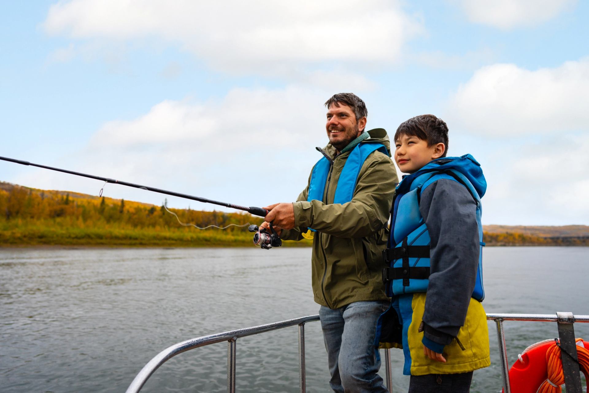 Two people fishing from a boat on calm water under a cloudy sky.