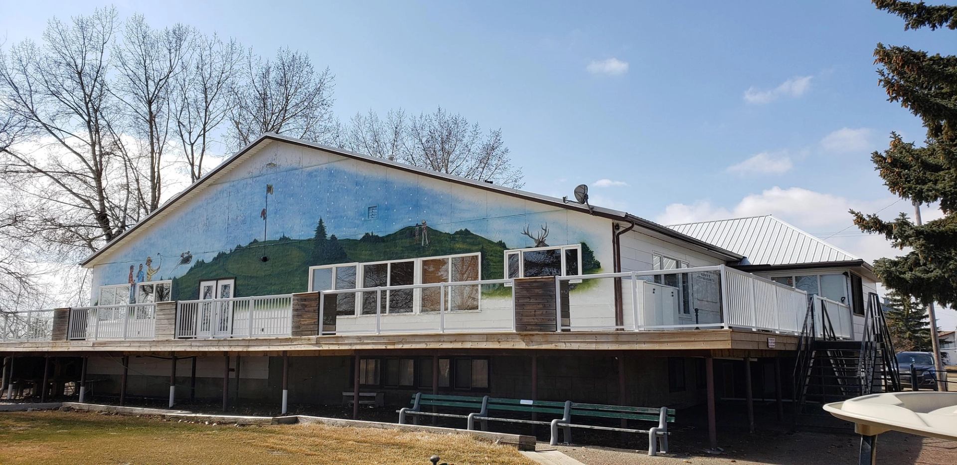 Golf clubhouse with mural of green hills and trees on upper wall