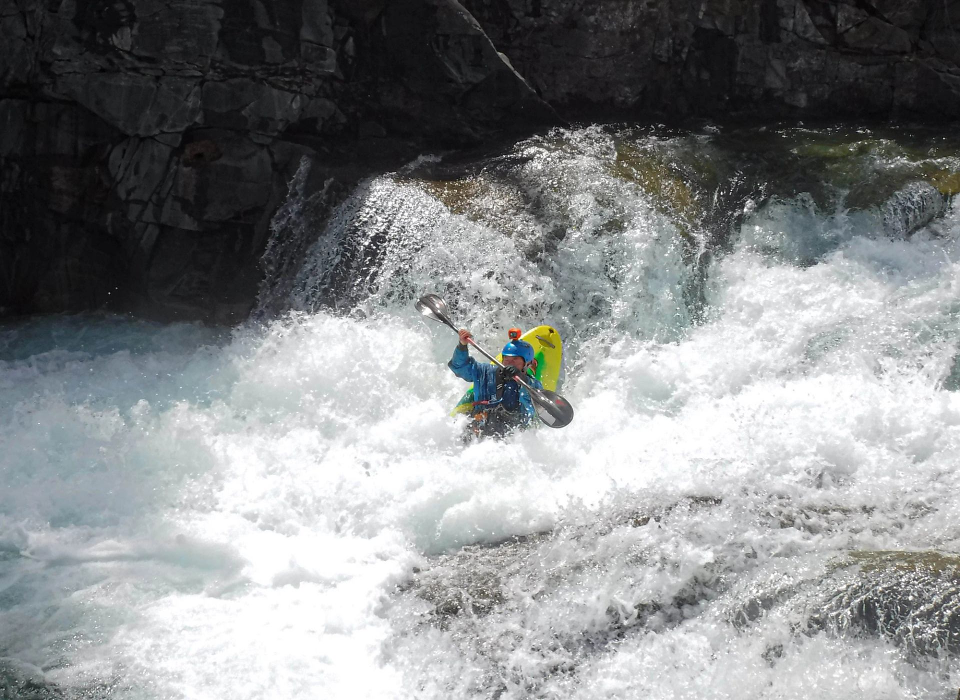 A person Kayaking down the river