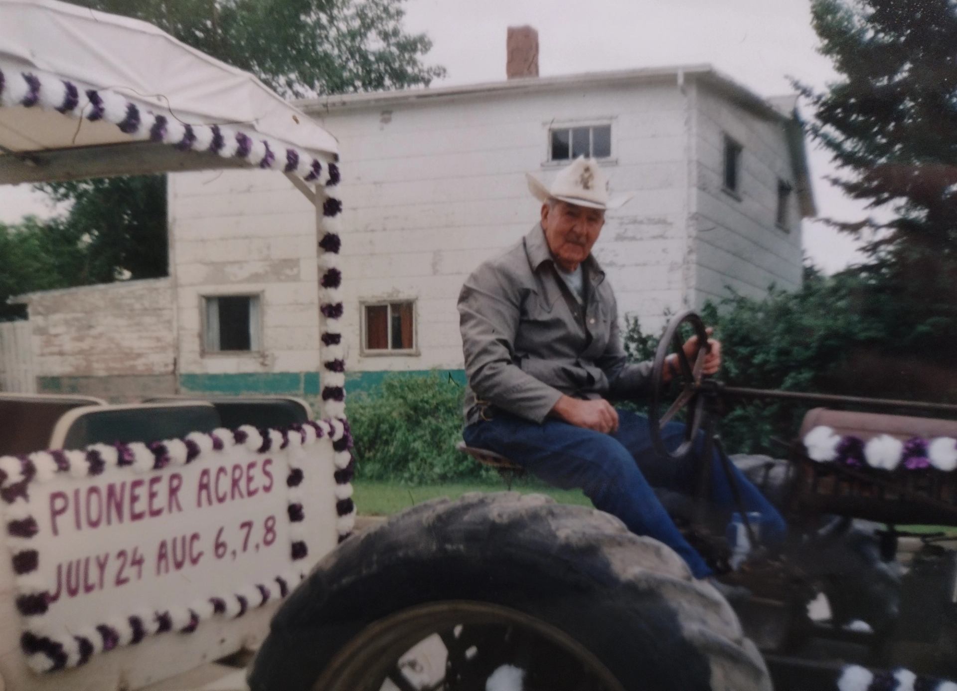 A man on a tractor pulling a parade float.