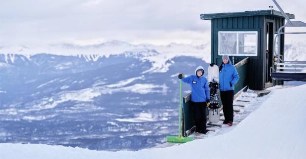 Two employees stand at the top of the chairlift at Marmot Basin in Jasper National Park