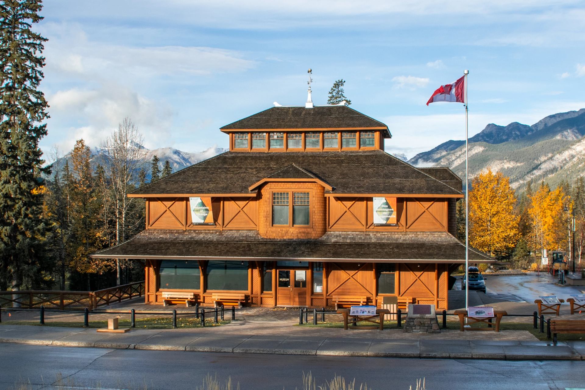 Rustic Banff Park Museum with autumn trees and mountain backdrop.