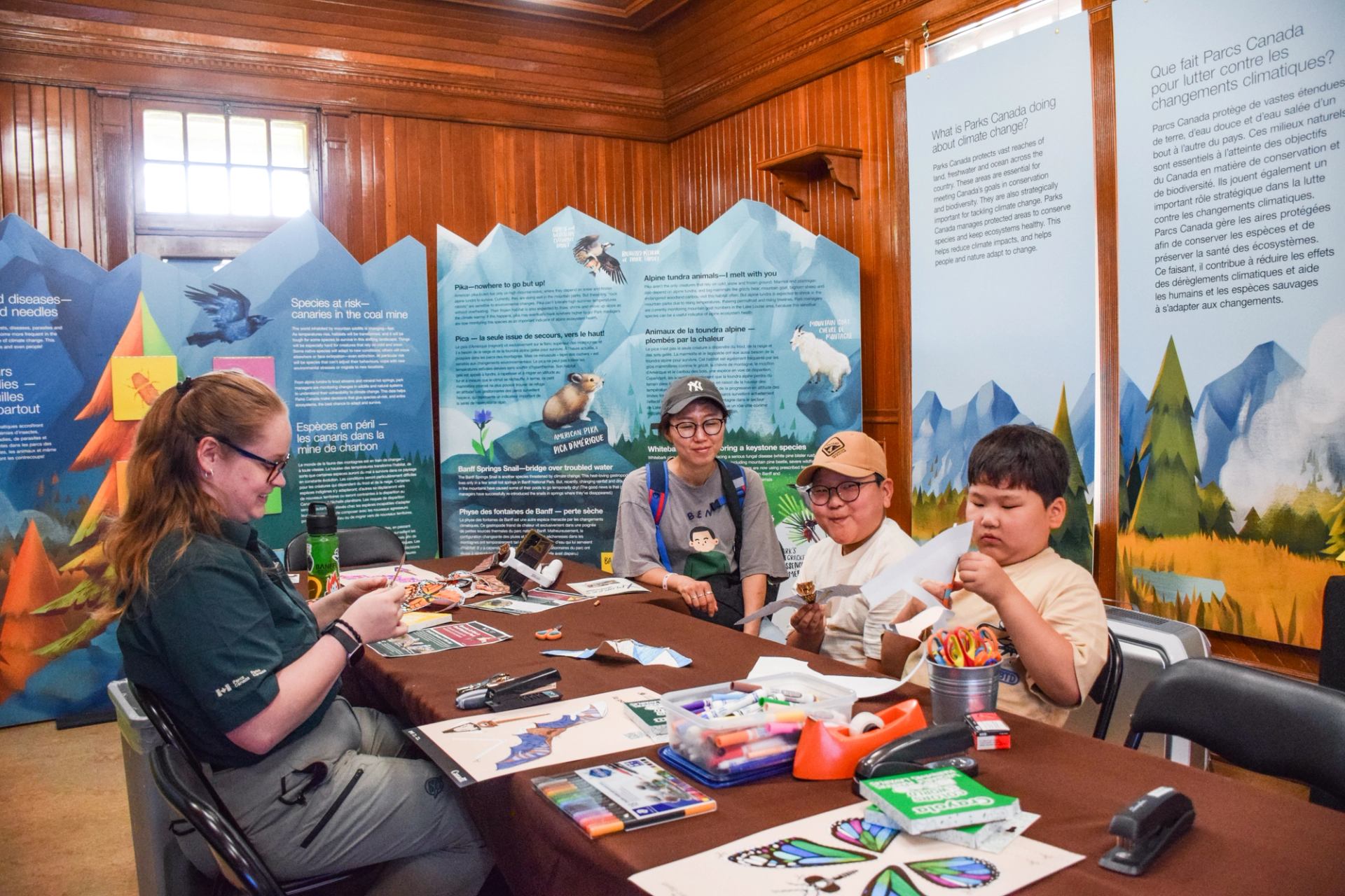 Family doing crafts with a Parks Canada presenter.