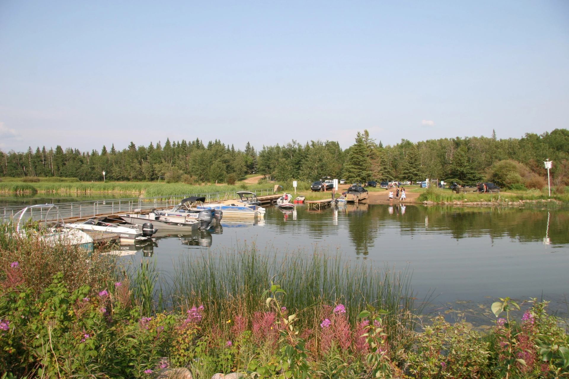 Boats moored at the Winagami Lake boat launch.