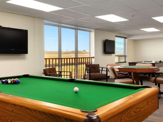 Game room at Days Inn with pool table and seating area.