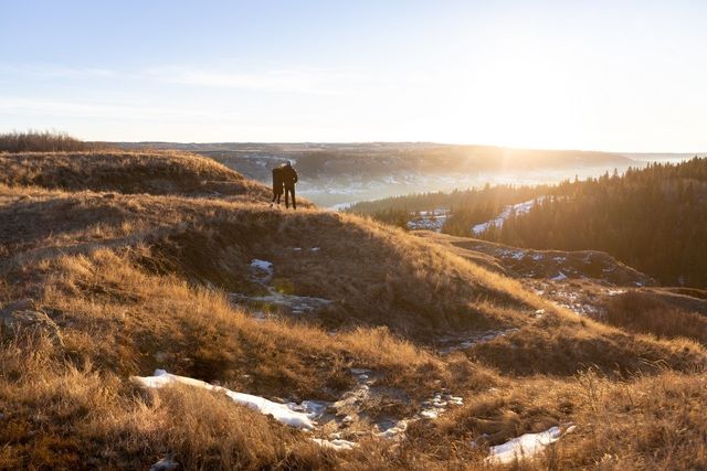 A couple walking on a hiking path at Running Reins Ranch nearing sunset