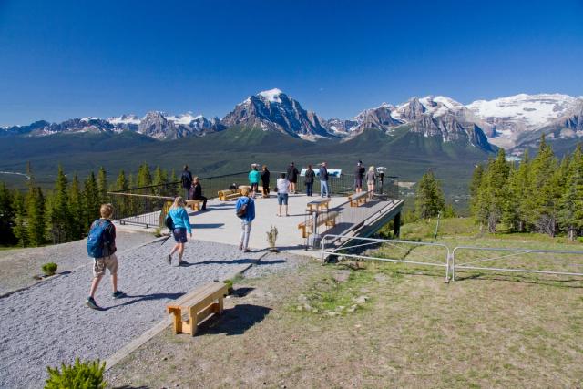 Group of people at the viewing platform with views of the mountains at Lake Louise Resort in Banff National Park.