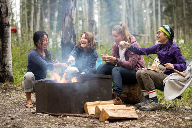 Friends gathered around a campsite at Pine Lake Campground.