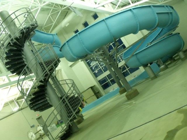 Blue spiral water slide indoors.
