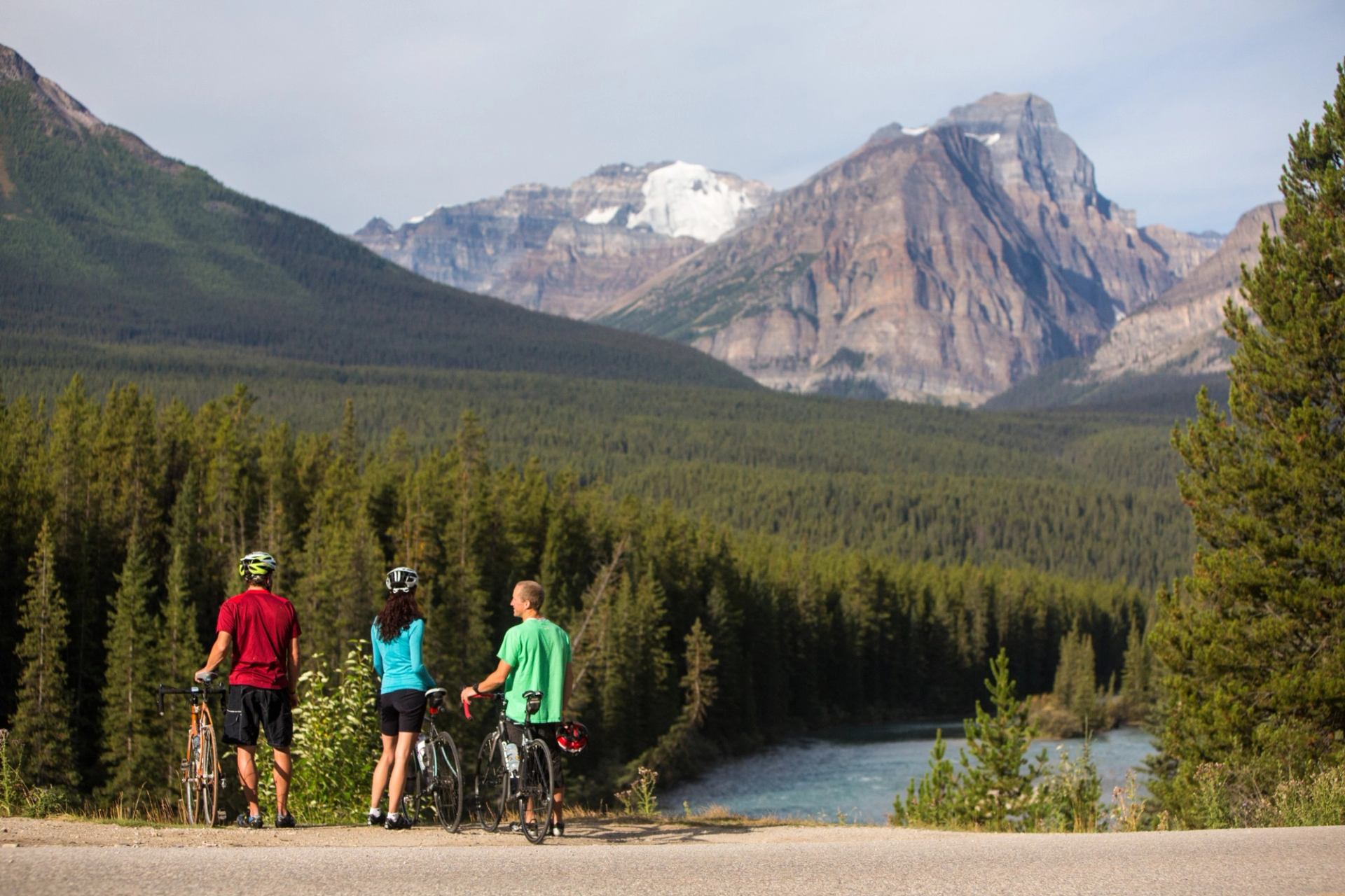 Three people stopped on their bikes taking in the views