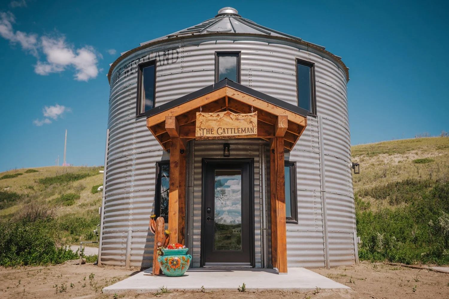Stay unique at Saddle Hill Ranch—grain silo cabin with modern design and scenic prairie views.