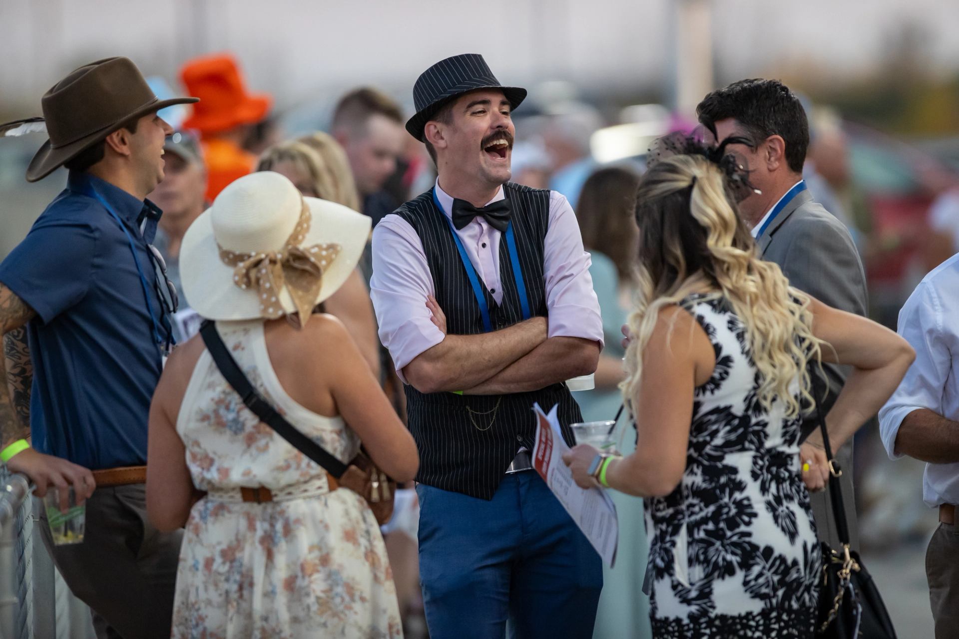 A group of people wearing hats at the race.