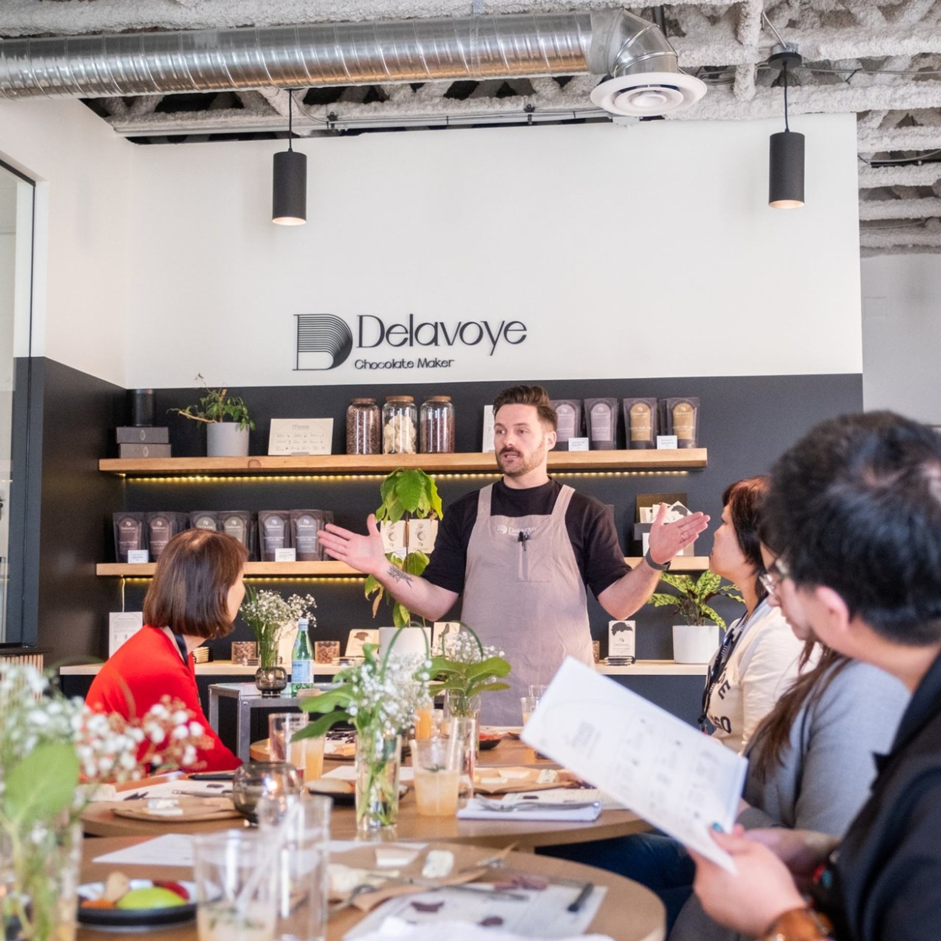 Group seated in café listening to host during 124th Food Walk Tour.