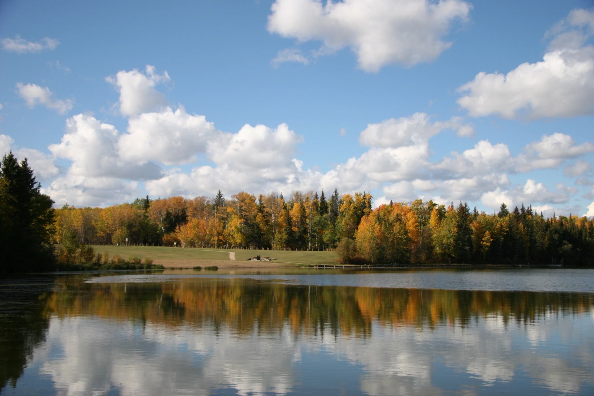 Calm lake reflects autumn trees and sky at Figure Eight Lake Campground.