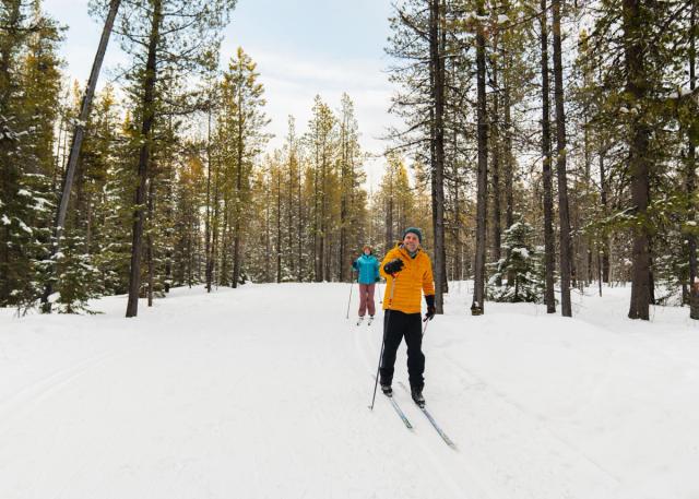 Two cross country skiers enjoying the trails while skiing in West Bragg Creek.