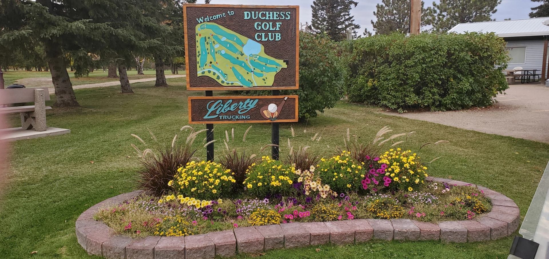 Colorful flower bed in front of Duchess Golf Club welcome sign