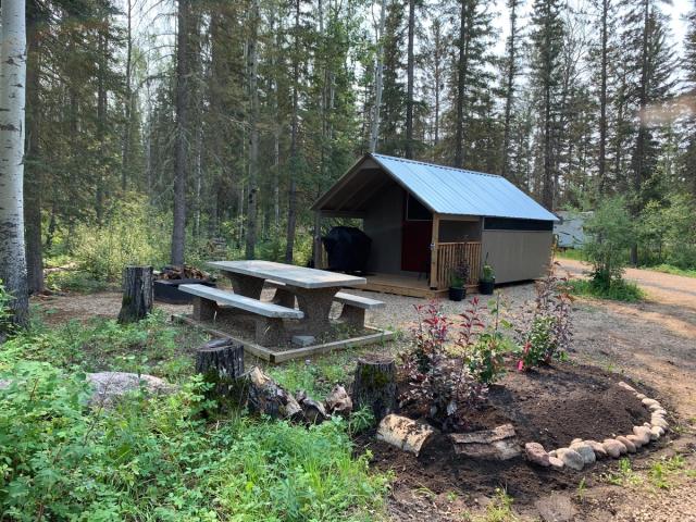 Exterior of cabin and picnic area at Zama City Campground.