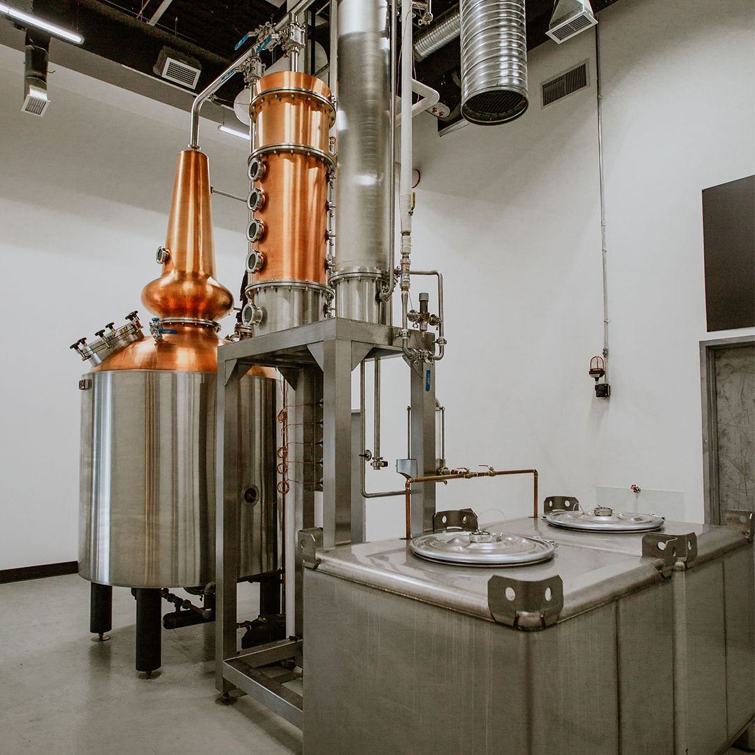 Large copper and steel distilling equipment inside the distillery