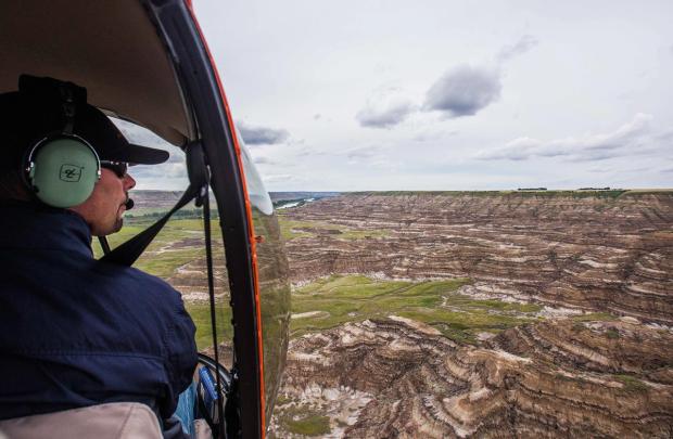 View of a helicopter pilot flying over Horsethief Canyon near Drumheller.