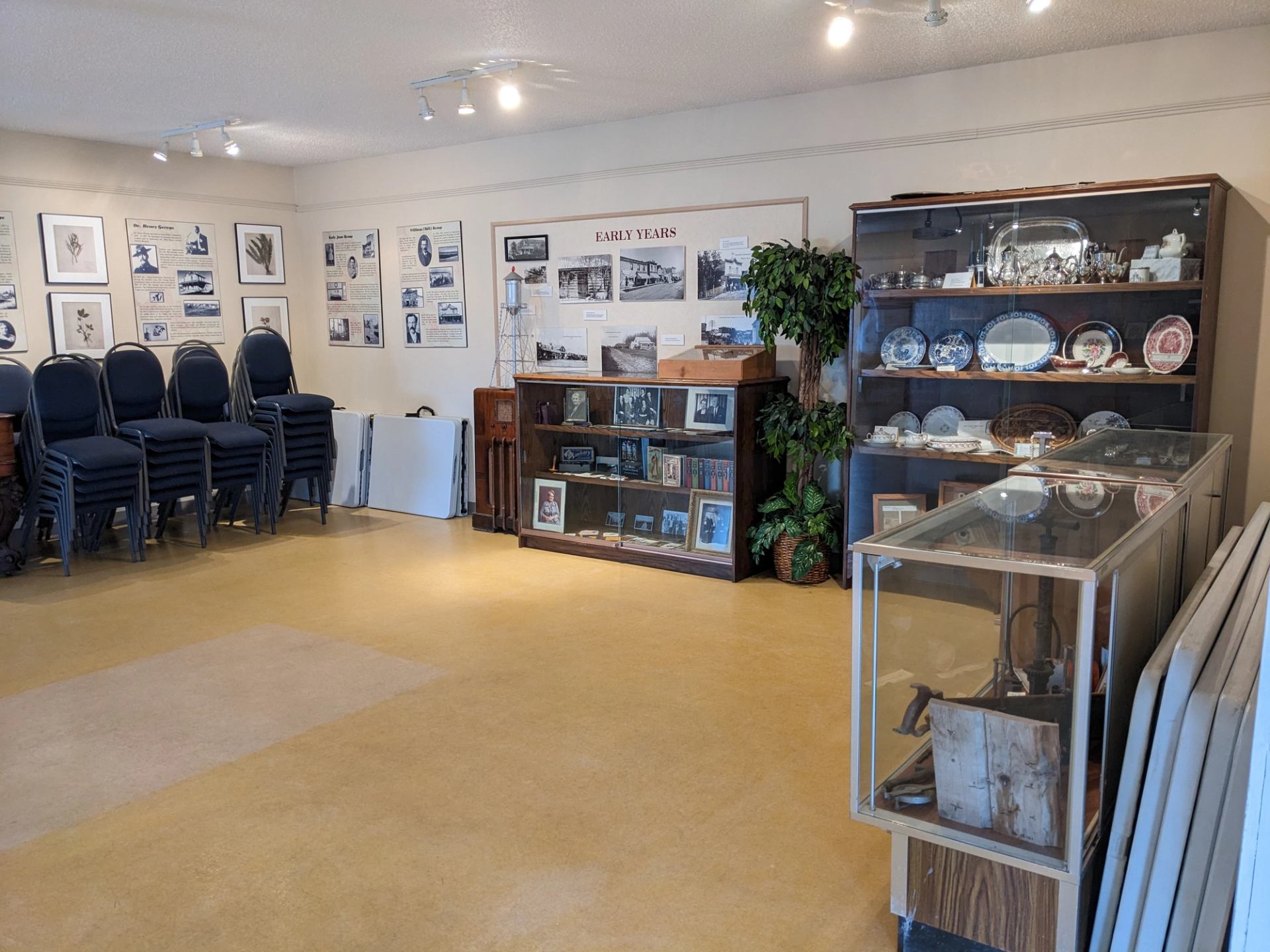 Tea room interior with historical displays, glass cases, and vintage furnishings.
