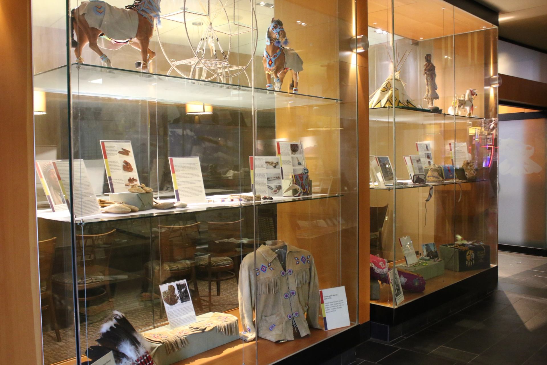 Case with clothing, horse models, and placards.