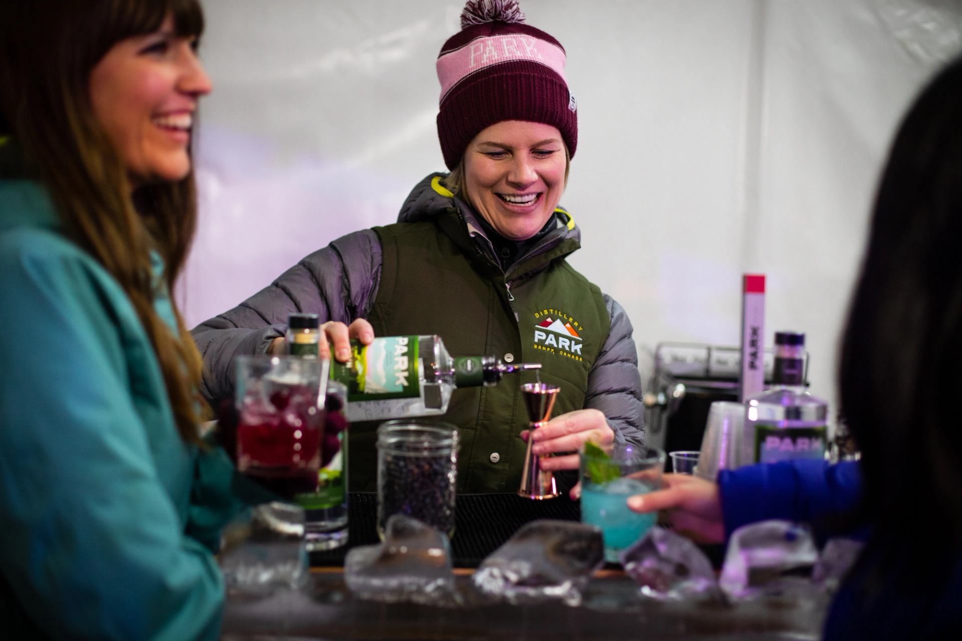 Bartender pouring a drink at Tribute to Craft cocktail and cuisine event.