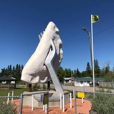 The World's Largest Perogy statue with a blue sky in the background.