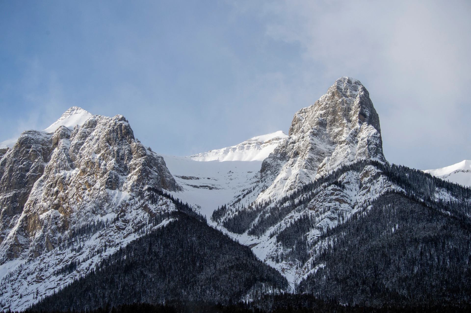 Snowy mountain peaks beneath a clear blue sky.