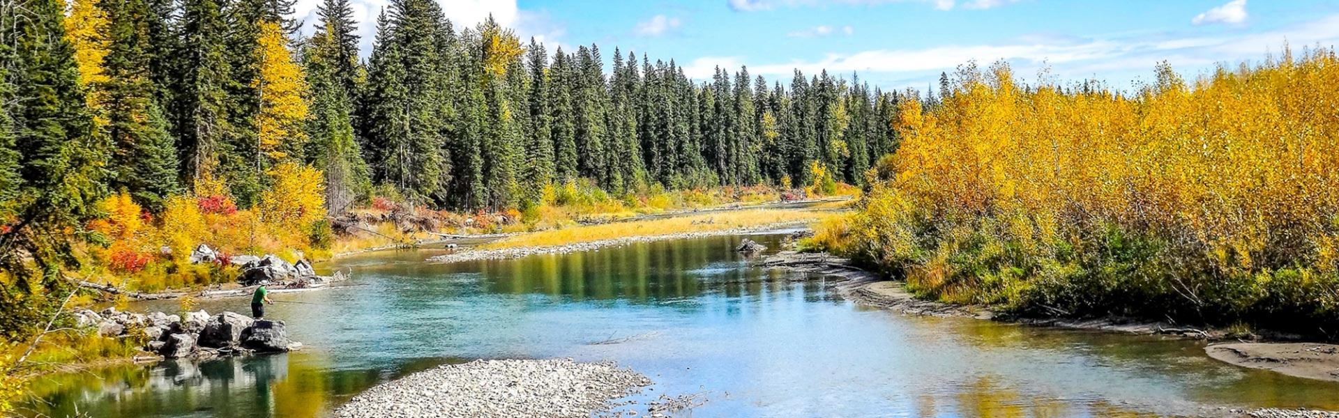 Scenic view of river, fall foliage, and person fishing at Horburg Provincial Recreation Area.
