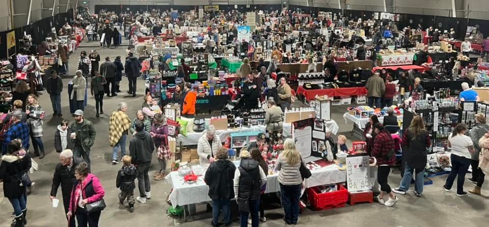 Shoppers explore rows of artisan vendors and local products inside the busy Olds Farmers' Market.