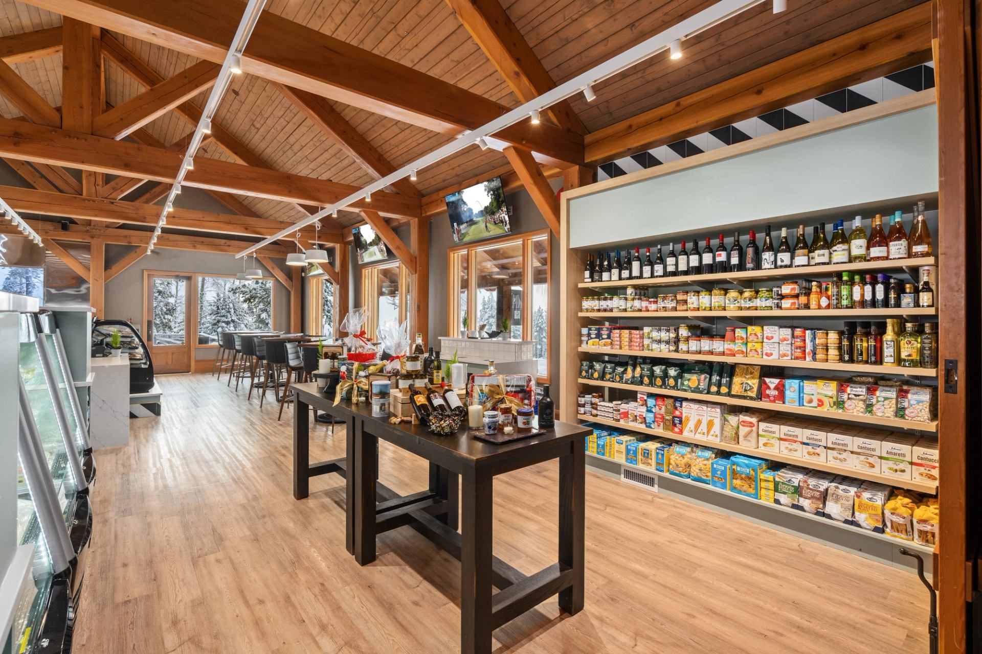 A market aisle with shelves of groceries and a central display table.