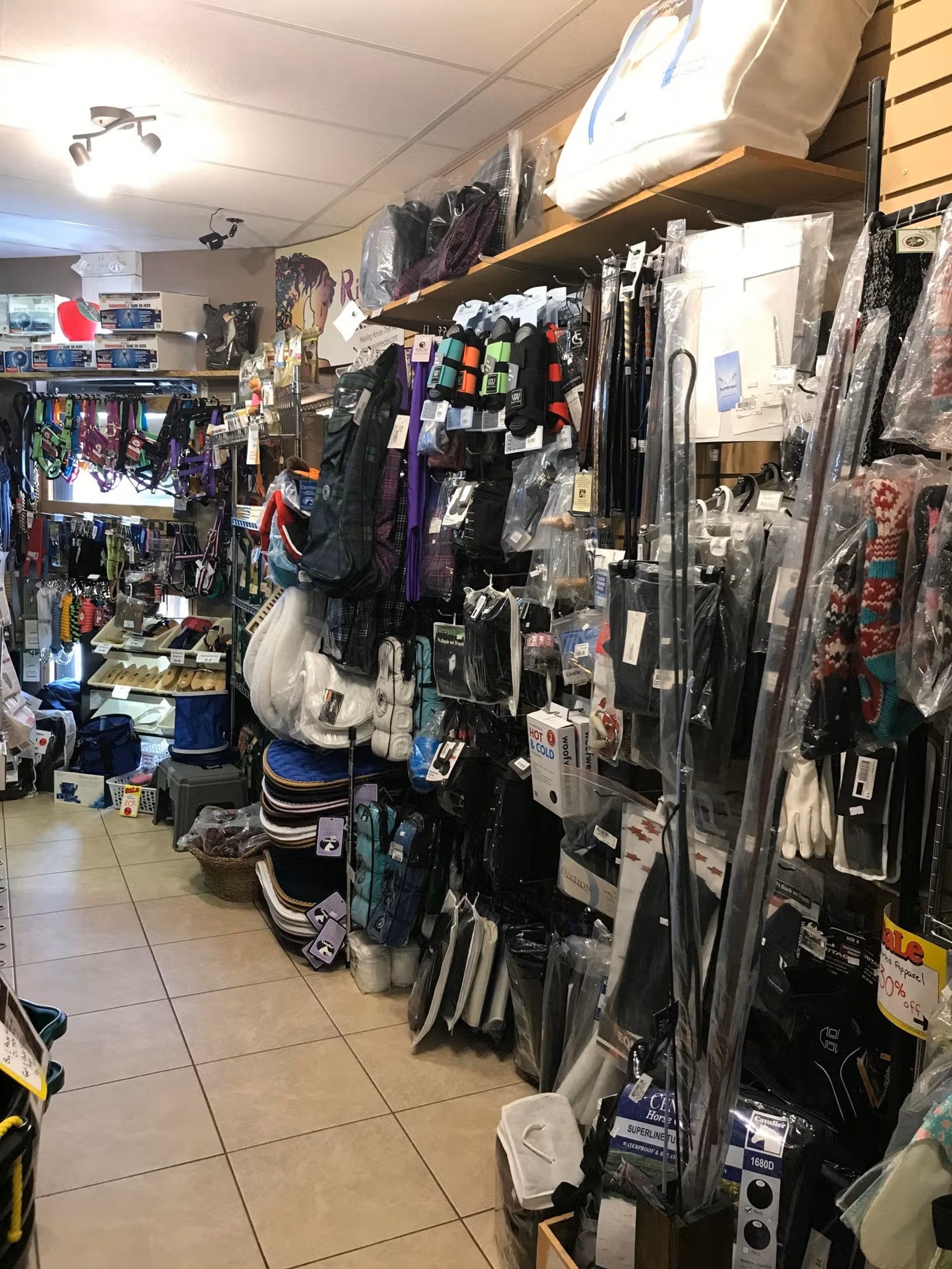 Aisles filled with pet accessories, gear, and supplies inside Chinook Windz store.