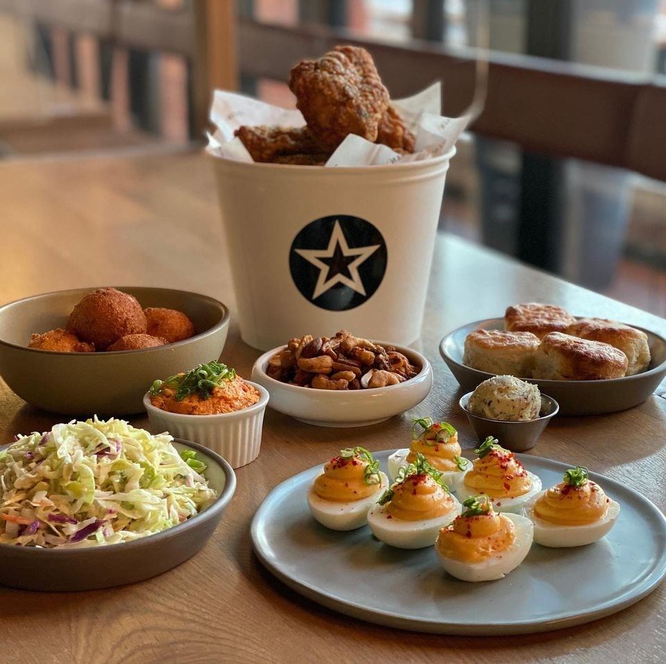 Bucket of fried chicken with deviled eggs, slaw, and assorted appetizers