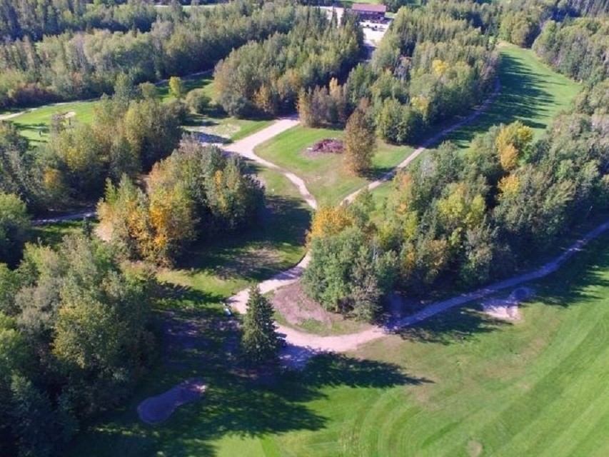 Golf course fairway with winding cart path and trees at Gilwood Golf and Country Club.