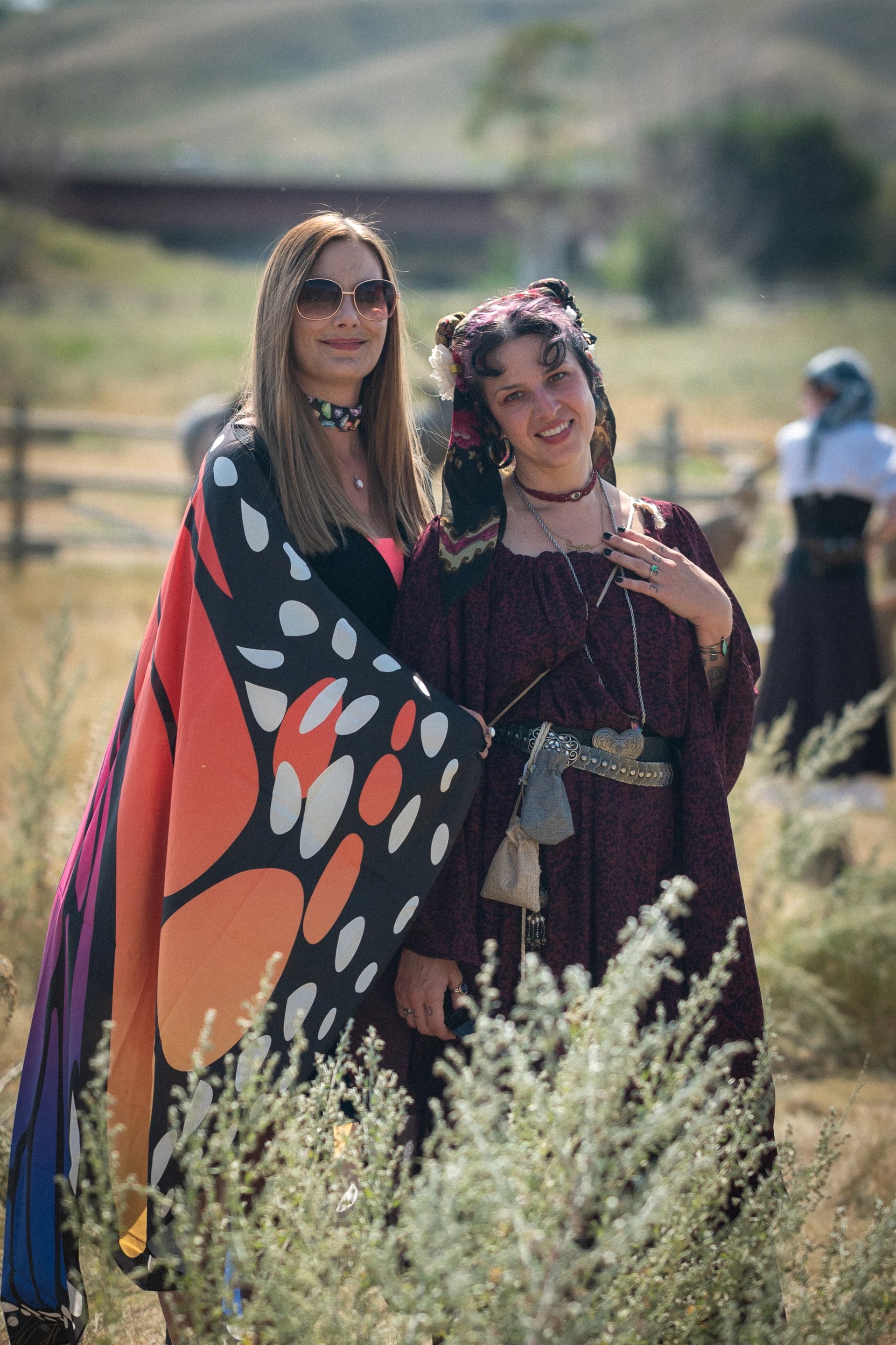Two women stand in medieval garb at the 2025 Renaissance Fare at Fort Whoop Up.
